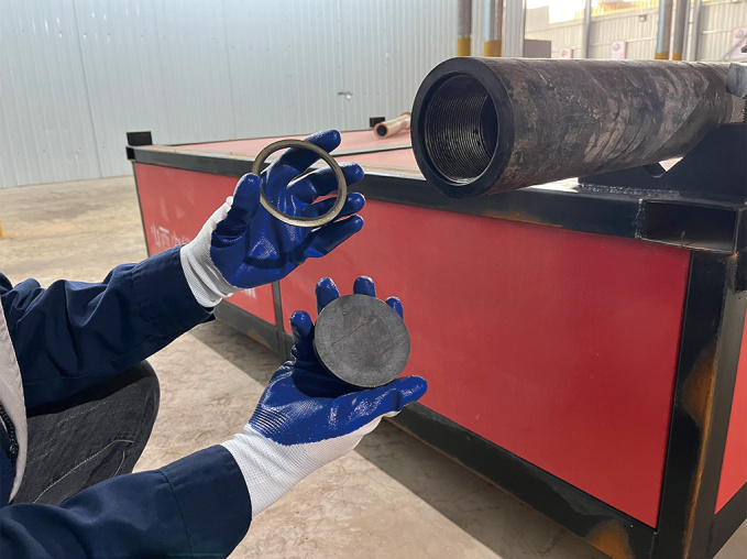 Place rock breaking steel pipe on filling table and clean threads